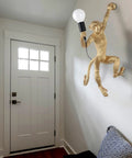 Modern Resin Monkey Wall Lamp With Hemp Rope Accent mounted in hallway, white wall background, vintage vibe pendant light.