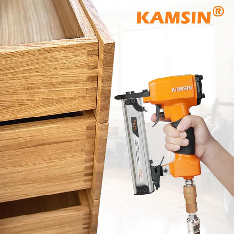 Ultra Lightweight 23 Gauge Pneumatic Pin Nailer for Cabinet and Door Install held near wooden drawer for precise trim work.