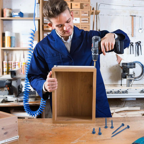Person using Pocket Hole Screws 2-1/2 Inch, 80 Pcs, No 8 Blue Coated Wood Screws for cabinetry construction indoors.