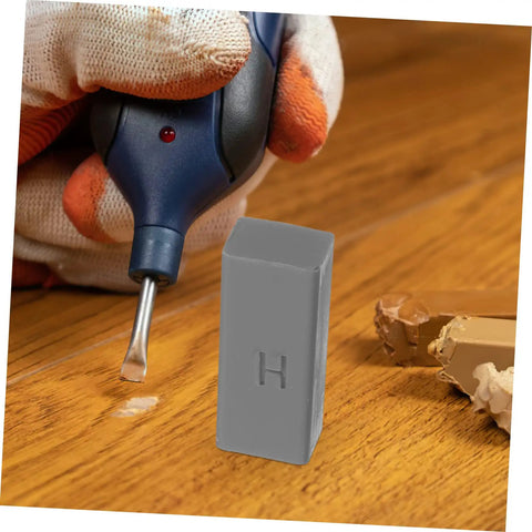 Gloved hand using tool with Floor And Tile Repair Wax Kit For Porcelain And Ceramic Tiles Quick Drying Hard Wax Filler on wood surface