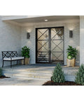 Exterior view with Dope Modern 5 Inch Outdoor Up And Down Wall Lantern In Black Finish flanking entryway doors on brick wall.