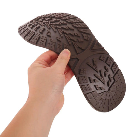 2 Pack Heavy Duty Rubber Sole Replacement Patches For Work Boots And Casual Sneakers in dark brown, held in hand.