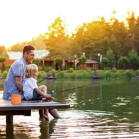 Child and adult fishing with Two Pack Kid Friendly Fishing Pole Kit With Portable Telescopic Rod Tackle Box Nets And Buckets by a lake