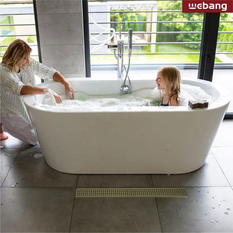 Bathroom with Super Efficient 36 Inch Linear Shower Drain In Brushed Gold, visible near bathtub floor, in SUS304 stainless steel.
