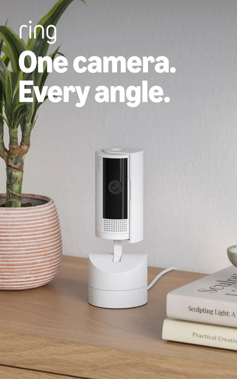 Sleek 360 Degree Pan Tilt Indoor Security Camera With Crisp Hd Video And Two Way Talk For Keeping Tabs On Your Space Plus Instant Smart App Alerts And Clean White Case For A Solid Setup You Know You Need Right Now on wooden table with plant and books