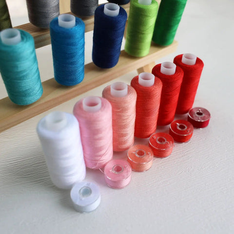 Top Shelf 72 Piece Sewing Thread Kit With 36 Vibrant Polyester Shades And Matching Bobbins display of colorful spools and bobbins.
