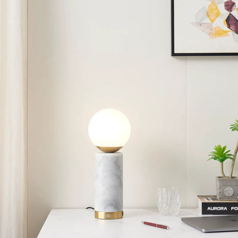 Aspen LED Table Lamp With USB Port For Bedside Or Desk Ambient Lighting And Marble Finish Globe Shade next to books and decor