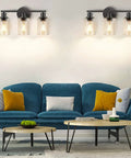 Living room with blue sofa, wall sconce lighting featuring Clear Glass Lamp Shade Replacement Globe For Chandelier Pendant And Wall Sconce Lighting Cylinder Glass Shade 5.5 Inch Tall 3.5 Inch Diameter 1.65 Inch Top Fitter Fits Most Fixtures.