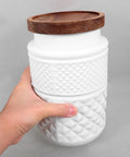 Top Shelf Durable 1800Ml Glass Storage Jars With Hella Tight Airtight Wooden Lids Vintage White Matte Tea Canisters held in hand.