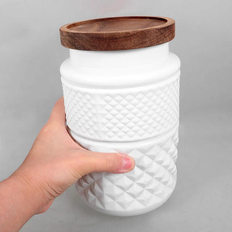 Top Shelf Durable 1800Ml Glass Storage Jars With Hella Tight Airtight Wooden Lids Vintage White Matte Tea Canisters held in hand.