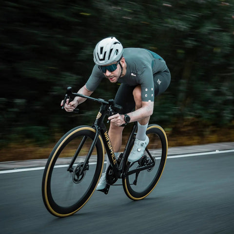Cyclist on road using Hyper 5 Road Bike Carbon Spoke Wheelset 700C Ultralight Disc Brake Clincher Tubeless Ready 40 50 60mm.