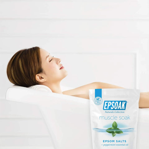 Muscle Recovery Epsom Salt Soak With Eucalyptus And Peppermint Essential Oils, 12 Lbs Total bag beside a relaxing bath scene