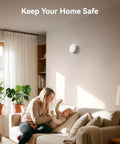 Heavy Duty Photoelectric Smoke Detector And Hardwired Fire Alarm With Interconnected Design and Reliable Battery Backup For Hassle Free Home Safety And Rapid Smoldering Fire Alerts In A Six Pack mounted on a wall in a cozy living room.