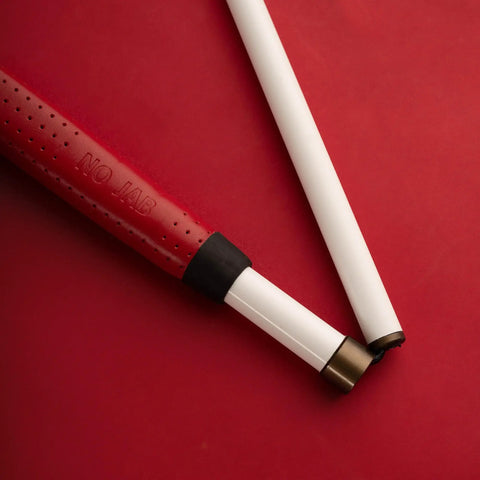 Graphite Cane With Rolling Marshmallow Tip, Lightweight Yet Stronger Than Aluminum, Foldable Shaft, red handle on red background