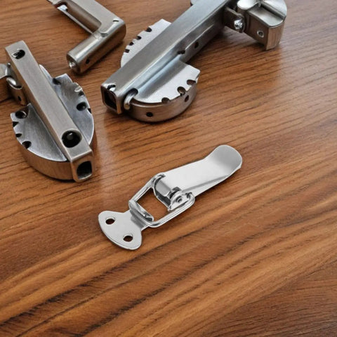 Stainless Steel Spring Toggle Lock Latches For Tool Box And Cabinet Doors With Smooth Action on a wooden surface.
