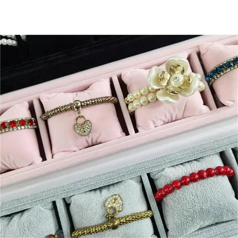 Two Pack Black Velvet Watch Tray Featuring Four Spacious Compartments And Plush Pillows To Keep Bracelets Secure displaying bracelets.