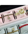 Black Velvet Watch Tray 2 Pack Four Grid Jewelry Organizer With Mini Pillows Bracelet Holder displaying various bracelets.