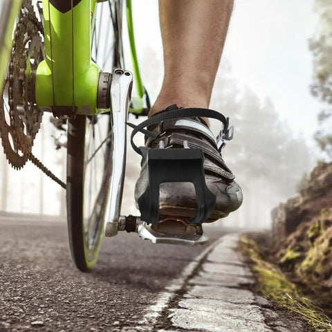 2 Pack Toe Clip Pedals With Straps For Road And Commuter Bikes shown on a bike in motion, showcasing secure footing and durable straps.