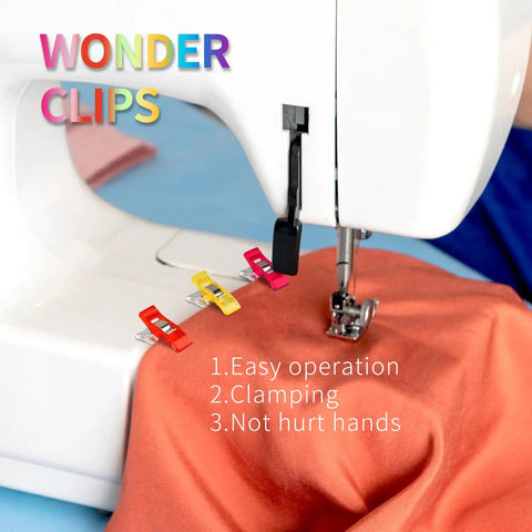 Super Handy Pack Of 100 Clear Plastic Sewing Clips snugged around orange fabric near a sewing machine for safe clamping.