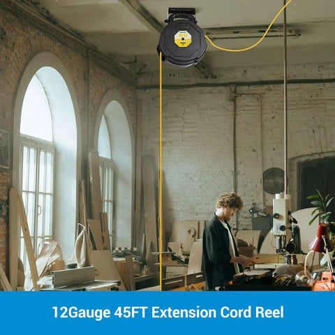 A 45Ft Retractable Extension Cord Reel With Auto Retract And Lighted Triple Outlets hanging in a workshop, mounted on the ceiling.