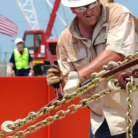 Worker using Hella Tough Grade 70 Cargo Chain Binders With Clevis Grab Hooks 3 8 Inch By 10 Feet 2 Pack 6600 Pound Working Load Limit for securing cargo.
