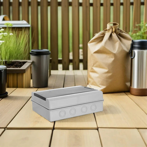 Rugged Weatherproof Outdoor Electrical Junction Box With Breaker Panel Cover and Reinforced Structure on wooden deck.