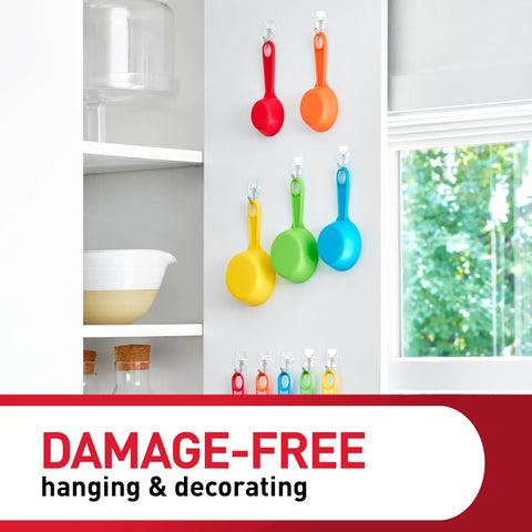 Clear Small Wire Toggle Hooks Set With 10 Wall Hooks And 12 Adhesive Strips holding colorful kitchen utensils on a wall.