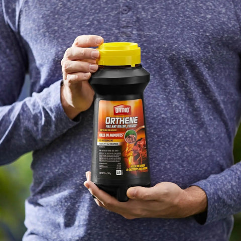 Person holding Fire Ant Killer Powder That Kills The Queen And Colony Fast For Lawns And Gardens No Watering Required Outdoor Treatment