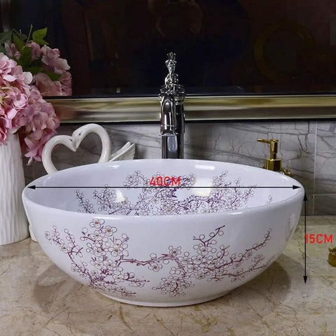 Top Shelf Above Counter Vessel Sink For Modern Bathroom Vanity High Gloss Art Porcelain Wash Basin Built Tough Ceramic Craftsmanship And No Sweat Install 40X15 Cm Slick Finish with floral design on a countertop.