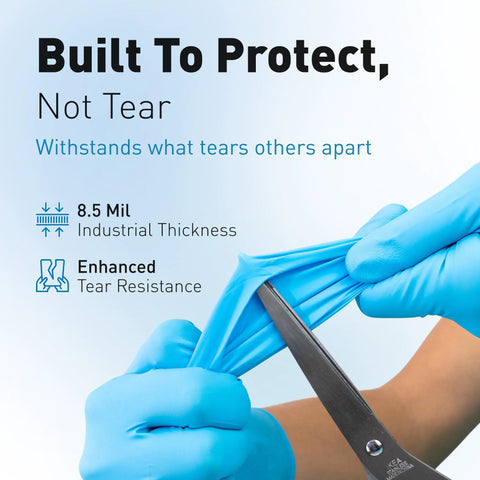 Blue disposable nitrile gloves being stretched by scissors; 8.5 mil thickness.