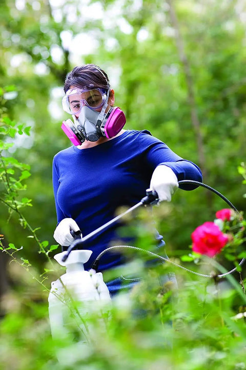 Woman wearing mask and gloves using Built Tough Chemical Splash Safety Goggles With Anti Fog Vents And Impact Resistant Polycarbonate Lenses And Jobsite Approved Eye Protection For Hard Working Pros And Tradesmen Ready For Any Messy Task.