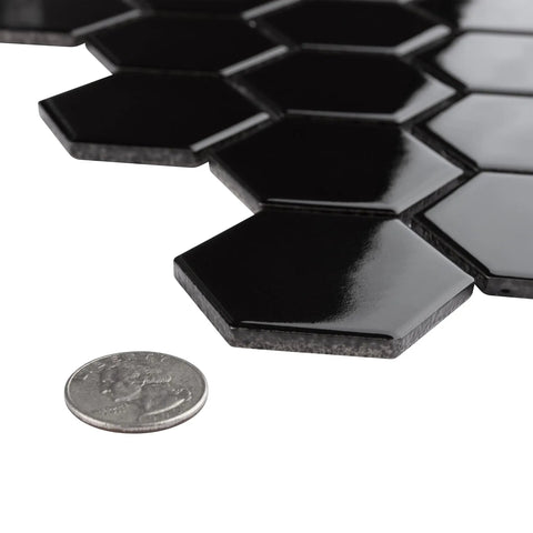 Dope Glossy Black Porcelain Hex Mosaic Tile, 2 inch pieces, showing high sheen finish next to a coin for size reference, mesh-mounted.