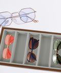 Slick Wooden Sunglasses Display Tray With Soft Gray Velvet Lining Seven Grid Eyewear Organizing Rack, holding four stylish sunglasses.