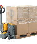 Heavy Duty 3300 Lb Electric Pallet Jack With Smart Control Handle And Fast Lifting next to wrapped cardboard boxes on a pallet.