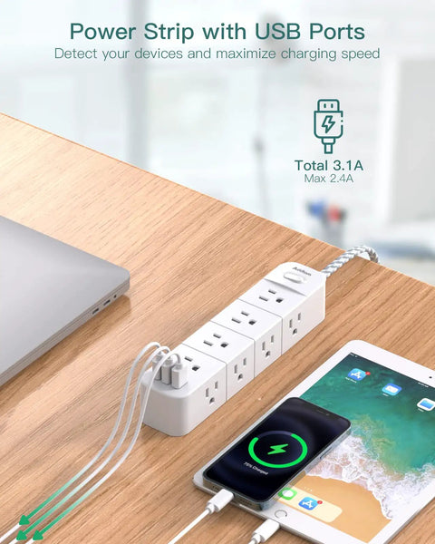 Surge Protector Power Strip With Twelve Outlets And Three USB Ports shown on desk with charging devices, flat plug visible.