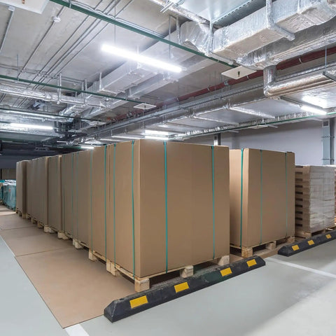 Large cartons secured with 25 Pack Galvanized Steel Cord Strapping Buckles 32mm Wide For Packaging And Shipping on pallets in a warehouse.