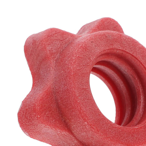 Close-up of red plastic anti skid barbell self locking nut from the four pack for home gym and weight lifting accessories.