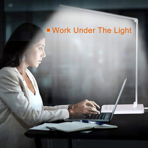Woman using laptop under Eye Caring LED Desk Lamp With USB Charging Port, Touch Dimmable Office Light, Memory And Timer, white color.
