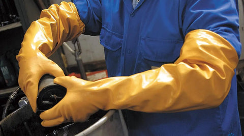 Worker uses Double Nitrile Coated Full Arm Chemical Resistant Safety Glove With Cotton Poly Liner, 20 Mil Thick, 26 Inch Length, X Large, 12 Pair Pack, Killer Grip For Oils, Grease, Abrasion, And Heavy Duty Work in industrial setting.
