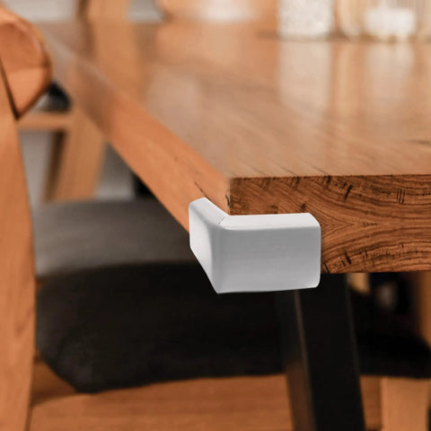 Premium Soft Foam Corner Protectors Grey Four Pack Furniture Edge Guards on wooden table corner for baby proofing.