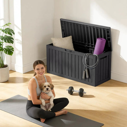 90 Gallon Waterproof Deck Box With Lockable Lid For Patio Storage Cushions Pool Gear Garden Tools And Packages Weatherproof Resin Outdoor Storage Bench open with yoga mat and pillows inside, woman sitting on yoga mat with dog