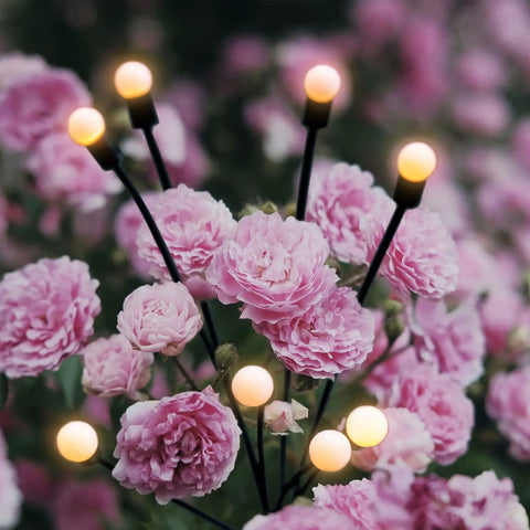 8 Pack Solar Powered Firefly Lights Outdoor Waterproof With Dual Modes Steady Glow And Flashing Swirling Warm White Garden Lights among pink flowers