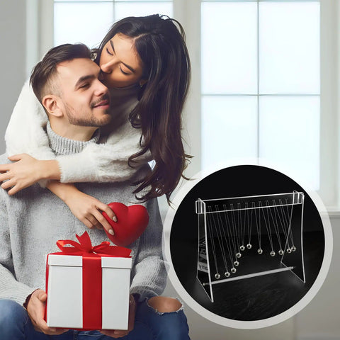 Couple with gift featuring 12 Ball Newtonian Pendulum Wave Desktop Decoration in white acrylic frame with stainless steel balls