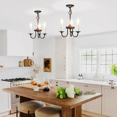 Three Light Farmhouse Candle Style Chandelier For Entryways, Dining Rooms, And Kitchen Islands above a rustic kitchen table