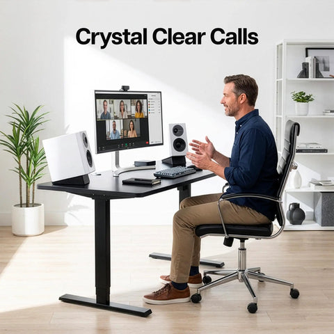 Man using desk setup with white speakers, highlighting Two Pack Desk Speaker Stands With 15 Degree Tilt For Bookshelf And Desktop Speakers 5 X 8 Inch Anti Vibration Risers For That Clean Loud Sound, Universal Fit, Studio Grade Audio Elevation, Black.