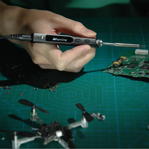 Digital OLED Programmable Mini Portable On The Go Soldering Iron Kit with DC5525 Power Interface in use on circuit board