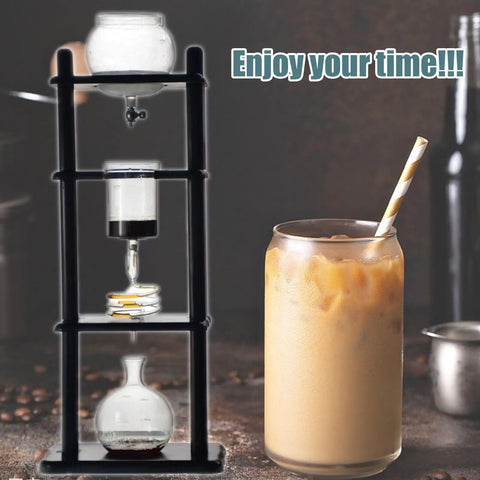 Top Shelf Cold Brew Maker With Slow Drip System For That Next Gen Iced Coffee Kick Pull Up To Eight Big Cups In Your Giant Thirty Five Oz Tower next to iced coffee in glass.