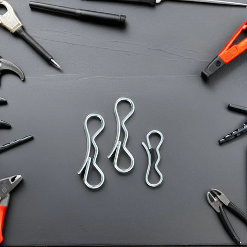 Cotter Pin Assortment Kit With Bow Tie Locking Clips And Heavy Duty Trailer Hitch Pins among tools on black surface