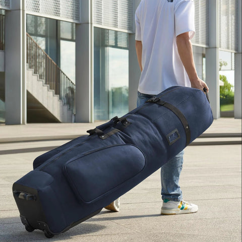Person carrying durable golf travel bag with wheels in blue