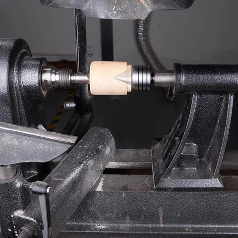 Side view: 2MT heavy-duty live tailstock center on a woodturning lathe with a light wooden workpiece between centers